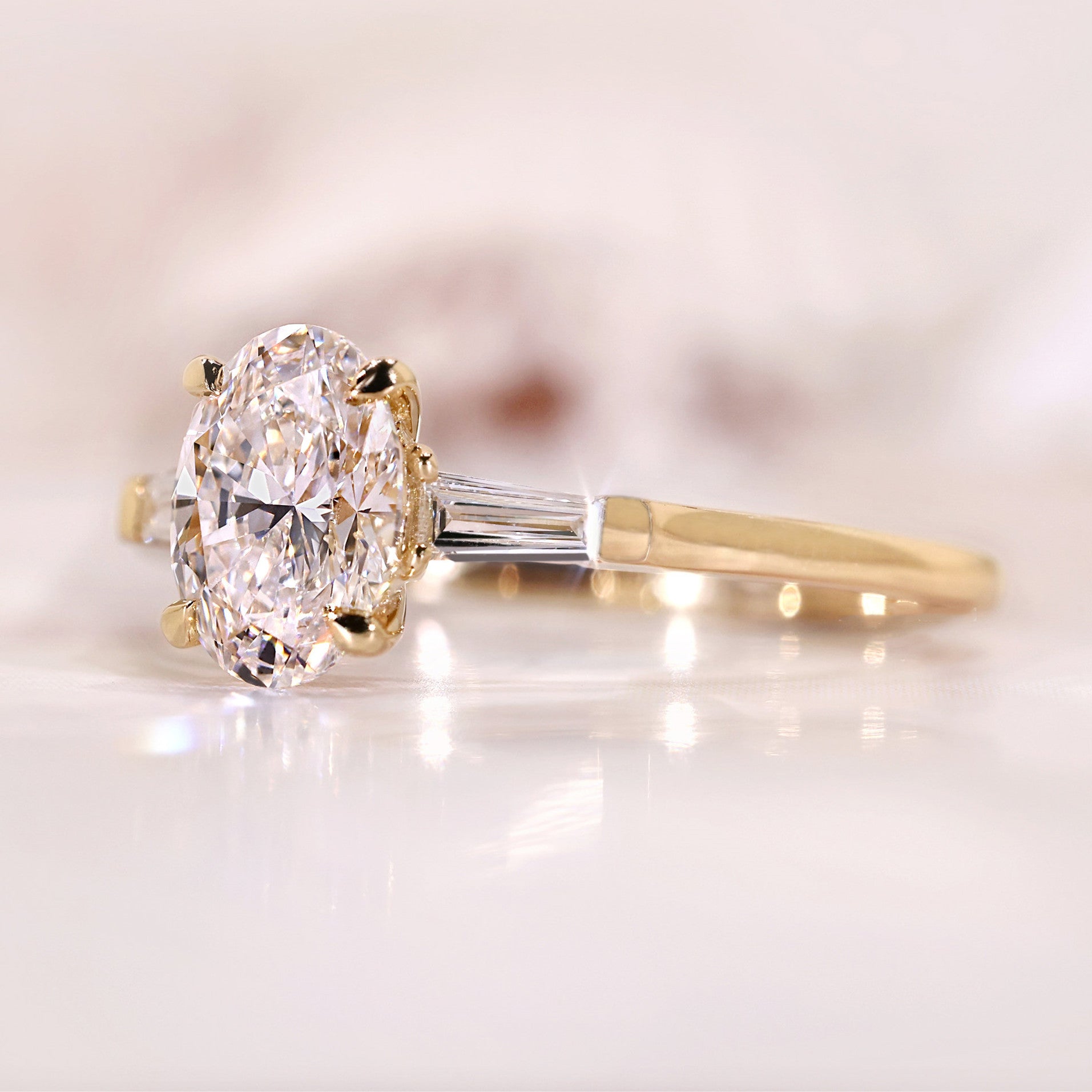 Three Stone Oval Cut with Side Tapered Baguette Cut Engagement Ring